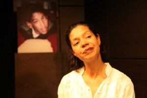 Jaye Griffiths on stage, with a photo of Nihal Armstrong